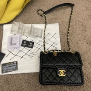 Black with gold tone Chanel mini flap handbag
